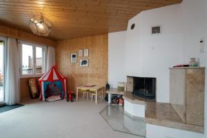 a living room with a tent and a table at Ferienhaus Bergblick in Amden