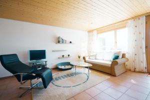 ein Wohnzimmer mit einem Sofa und einem Tisch in der Unterkunft Apartment Brugg in Amden