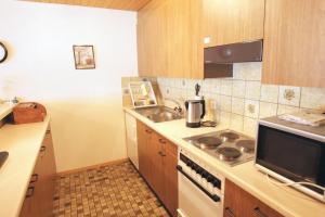 a small kitchen with a sink and a stove at Apartment Kaiser in Amden