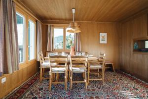 uma sala de jantar com mesa e cadeiras em Chalet Engihalde em Amden