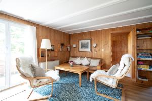 a living room with two chairs and a table at Chalet Sönderli in Amden