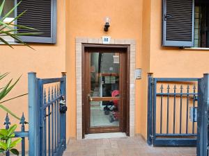 a door to a building with blue gates at Ciclamino Appartamento Roma in Infernetto