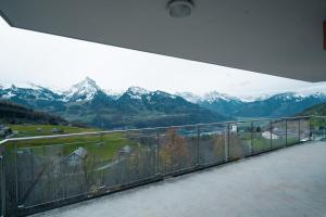 a balcony with a view of a mountain range at Apartment Elona in Amden