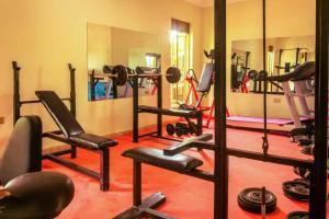 a gym with a lot of equipment in a room at Beri Cottages in Arua