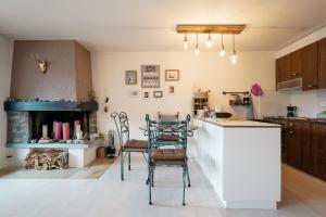 a kitchen with two chairs and a table and a counter at Apartment Mattstogg mit Charme in Amden