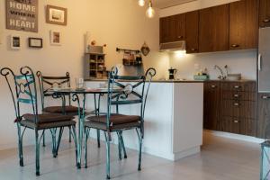 a kitchen with a table and chairs in a kitchen at Apartment Mattstogg mit Charme in Amden