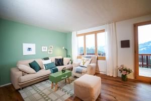 a living room with a couch and a table at Chalet Fridolin in Amden