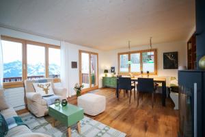 a living room with a couch and a table at Chalet Fridolin in Amden