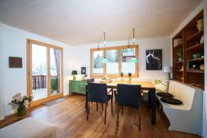 a kitchen with a dining room table and chairs at Chalet Fridolin in Amden