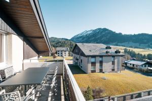 a balcony with chairs and a view of a mountain at Apartment zum Leist in Amden