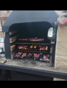 a brick oven with food inside of it at Chalet vacacional en Pelayos in Pelayos de la Presa