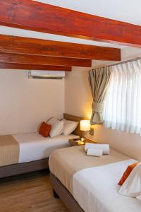 Postel nebo postele na pokoji v ubytování Tagle Hotel Boutique