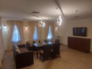 a dining room with a table and chairs and a tv at ONOVO Dendra Hotel in Kyiv