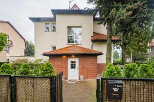 a house with a gate in front of it at Willa Zacisze - Pokoje Gościnne in Wrocław