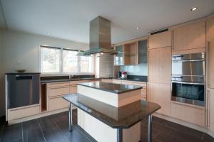 a kitchen with a island in the middle of it at Haus Gmür Amden Erdgeschoss in Amden