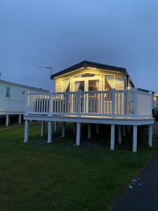 a large house with a large deck on the grass at Beautiful sea view 3 bedroomed Holiday Home Caravan in Exmouth