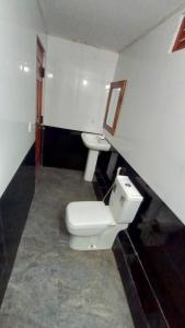 a bathroom with a toilet and a sink at 'Villa'chava in Chavakachcheri