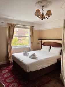 a bedroom with a bed with towels on it at The Mountford Hotel - Free Parking in Liverpool