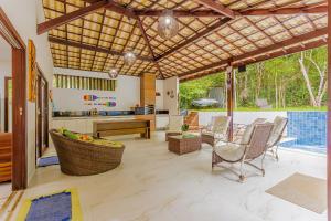an open kitchen and living room with a patio at PF26 Excelente Casa 4 Suítes - Praia do Forte in Mata de Sao Joao