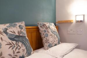 a bed with a pillow and a pillow with a bird on it at Taigh Toilichte in Fort William