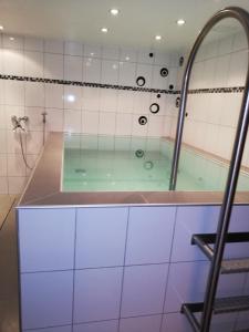 a bathroom with a tub with a glass shower at Ferienwohnung Florina im Hotel Casada in Galtür +14 photos