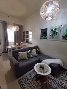 a living room with a couch and a table at 2BR Penthouse in Brixton Place with breathtaking view of BGC in Manila