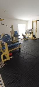 a gym with two treadmills and chairs in a room at Beira-Mar flat 310 Ponta Negra Beach in Natal