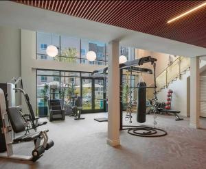 a gym with cardio equipment in a large building at Huge 2bd Apt Near Disneyland & Anaheim Conv Centr in Orange