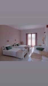 a large room with three beds in it at Lunzi Verde in Laganas