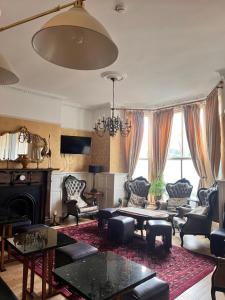 a living room filled with furniture and a chandelier at Beech Mount Hotel - Free Parking in Liverpool