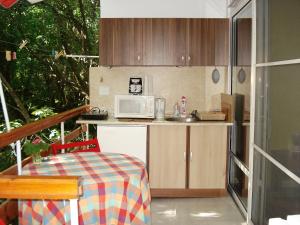 a small kitchen with a microwave and a table at Villa Exotica in Balchik