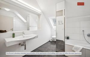 a white bathroom with a sink and a shower at Budget Living in the outskirts of Zurich in Dietikon