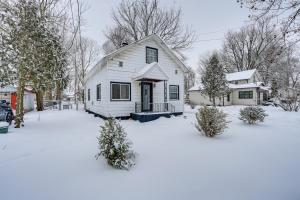 a white house with snow on the ground at Niles Vacation Rental Near St Joseph River! in Niles