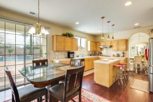 a kitchen with a glass table and a dining room at Spacious Clovis Vacation Rental with Outdoor Oasis! in Clovis