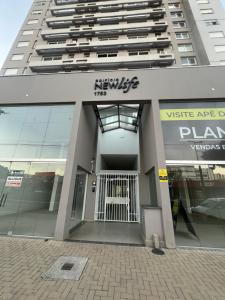 a large building with a gate in front of it at Apartamento/Studio Novo Hamburgo in Novo Hamburgo