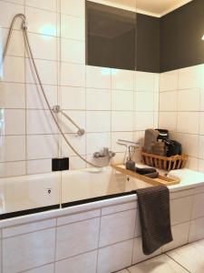 a white bathroom with a sink and a shower at Alte Schusterei direkt am Fluss und Altstadt in Oberndorf