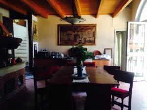 a dining room with a wooden table and chairs at B&B Il Castello del Ghiro RENT E-BIKE in Manta
