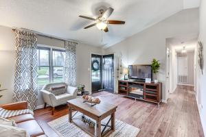 a living room with a ceiling fan and a tv at Mebane Home with Private Yard Steps to Downtown! in Mebane