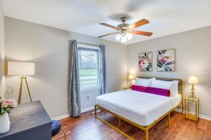 a bedroom with a bed and a ceiling fan at Mebane Home with Private Yard Steps to Downtown! in Mebane