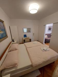 a small bedroom with a bed and a lamp at Villa Volga in Jelsa