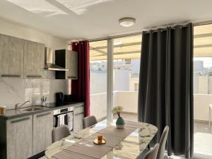 a kitchen and dining room with a table and chairs at Marina Apartments in Msida +92 photos