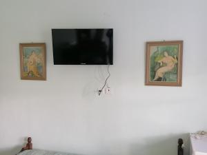 TV de pantalla plana en una pared blanca con 2 imágenes en oasis studio, en Diafani