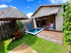 a house with a deck and a swimming pool at Chalés Milagres Beach in São Miguel dos Milagres