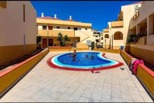 a group of people in a swimming pool in a building at House Harvey J53 Mareverde in Adeje