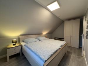 a bedroom with a large bed and a ceiling at Windfang 1 in Hooksiel in Wangerland +8 photos