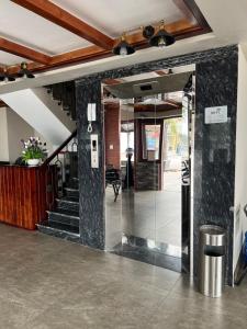 a lobby with a staircase and a glass door at Cánh Buồm Homestay - Tuần Châu in Ha Long