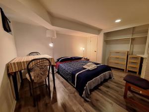a bedroom with a bed and a table in it at Spacious Room next to Subway Line 1 Midtown Toronto in Toronto