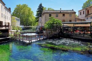 a body of water in a city with buildings at Maison de vacances Aubignan in Aubignan