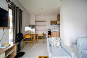 a living room with a couch and a table at Comfortable Villa in Quiet Area in Nusa Dua