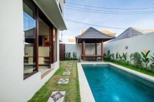 a swimming pool in the backyard of a house at Comfortable Villa in Quiet Area in Nusa Dua